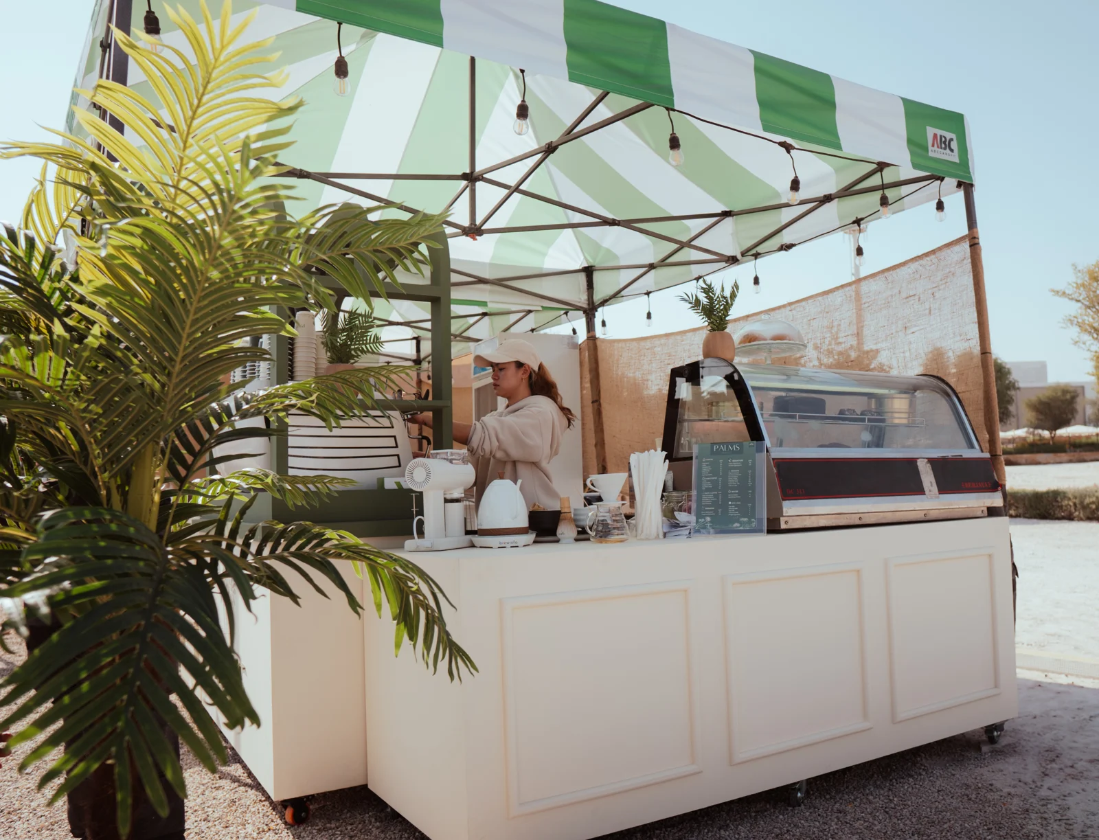 Outdoor PALMS coffee bar with greenery