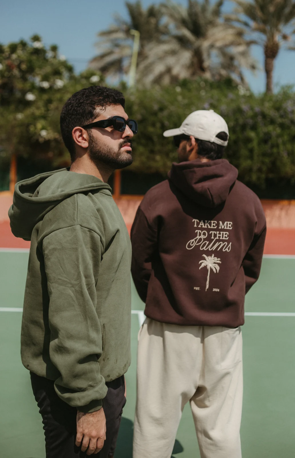 Models wearing green and brown PALM’S hoodies