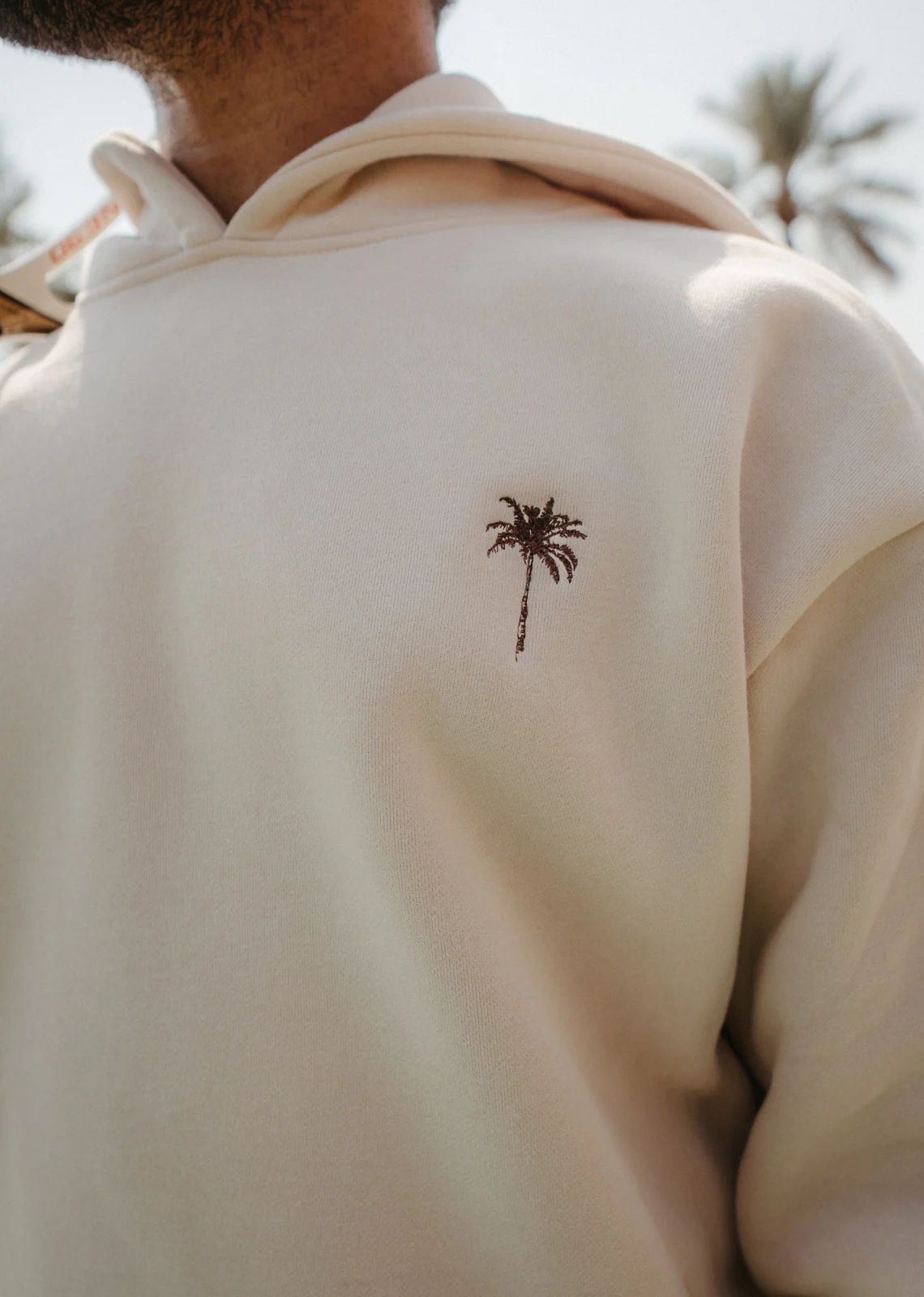 Close detail of a white PALM’S hoodie